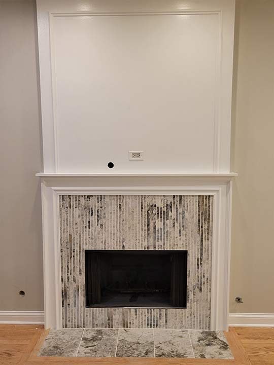 fireplace2-after a newly remodeled fireplace with white marble surround